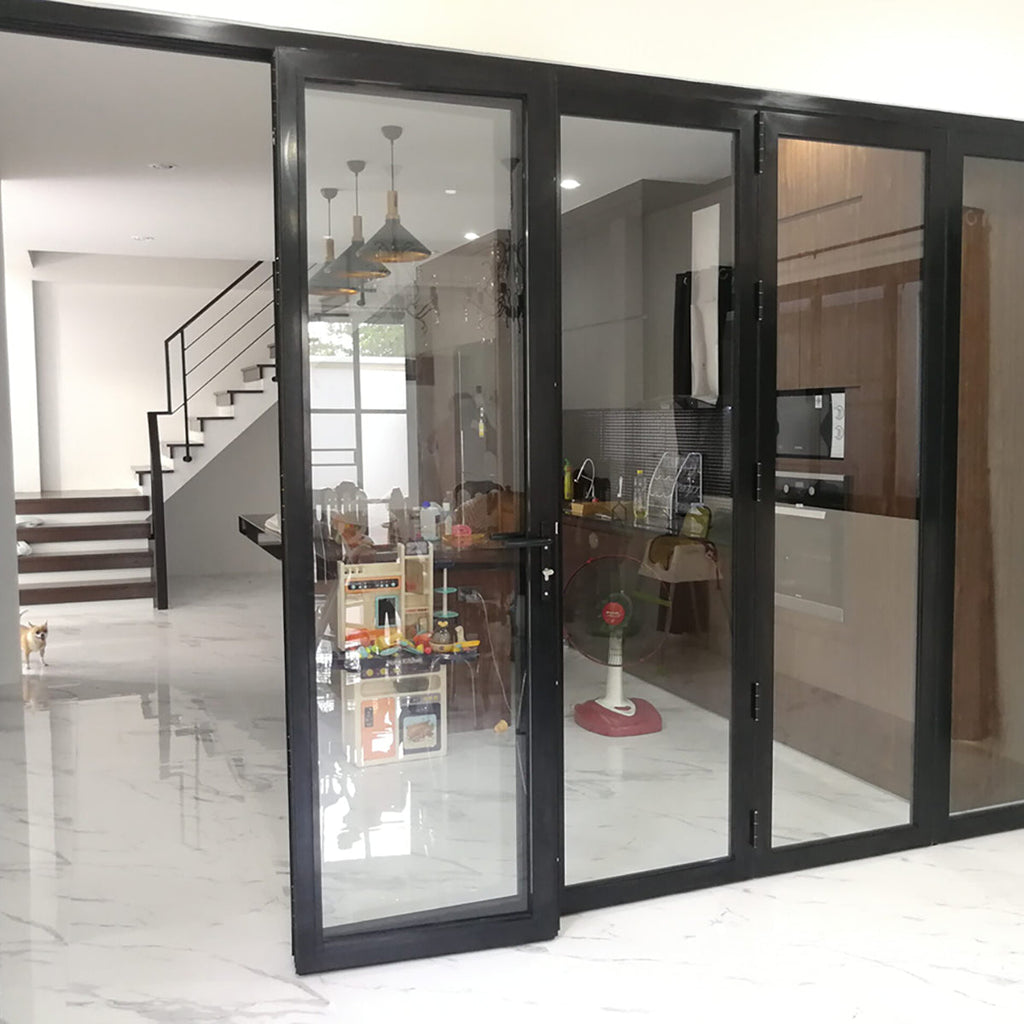 Modern interior with glass sliding doors leading to a kitchen.
